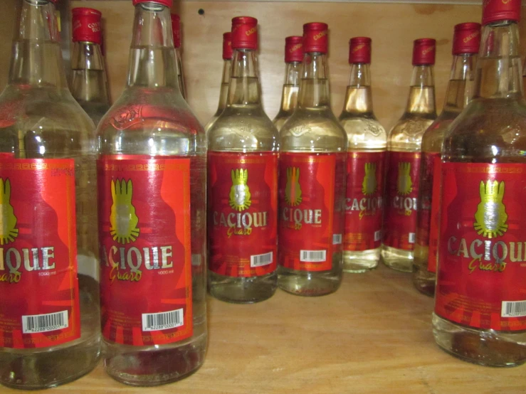 rows of bottles are on the shelf with labels