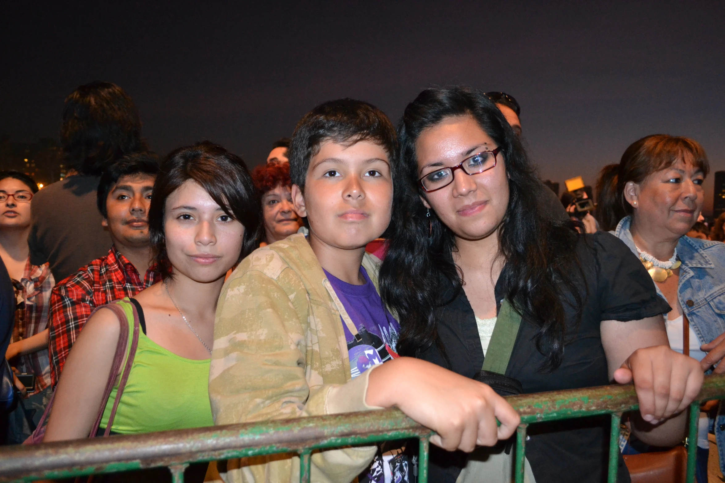 young people are watching an event from the balcony