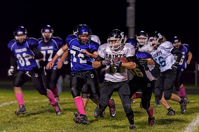 the football team runs the ball to the goal line