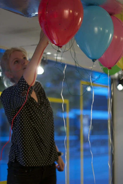 an old lady that is holding some balloons