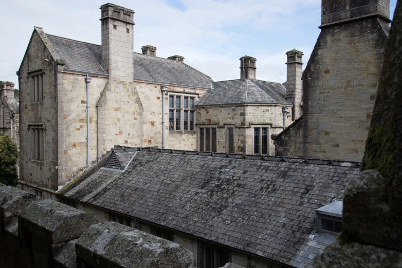 an aerial view of the roofs and windows of old building
