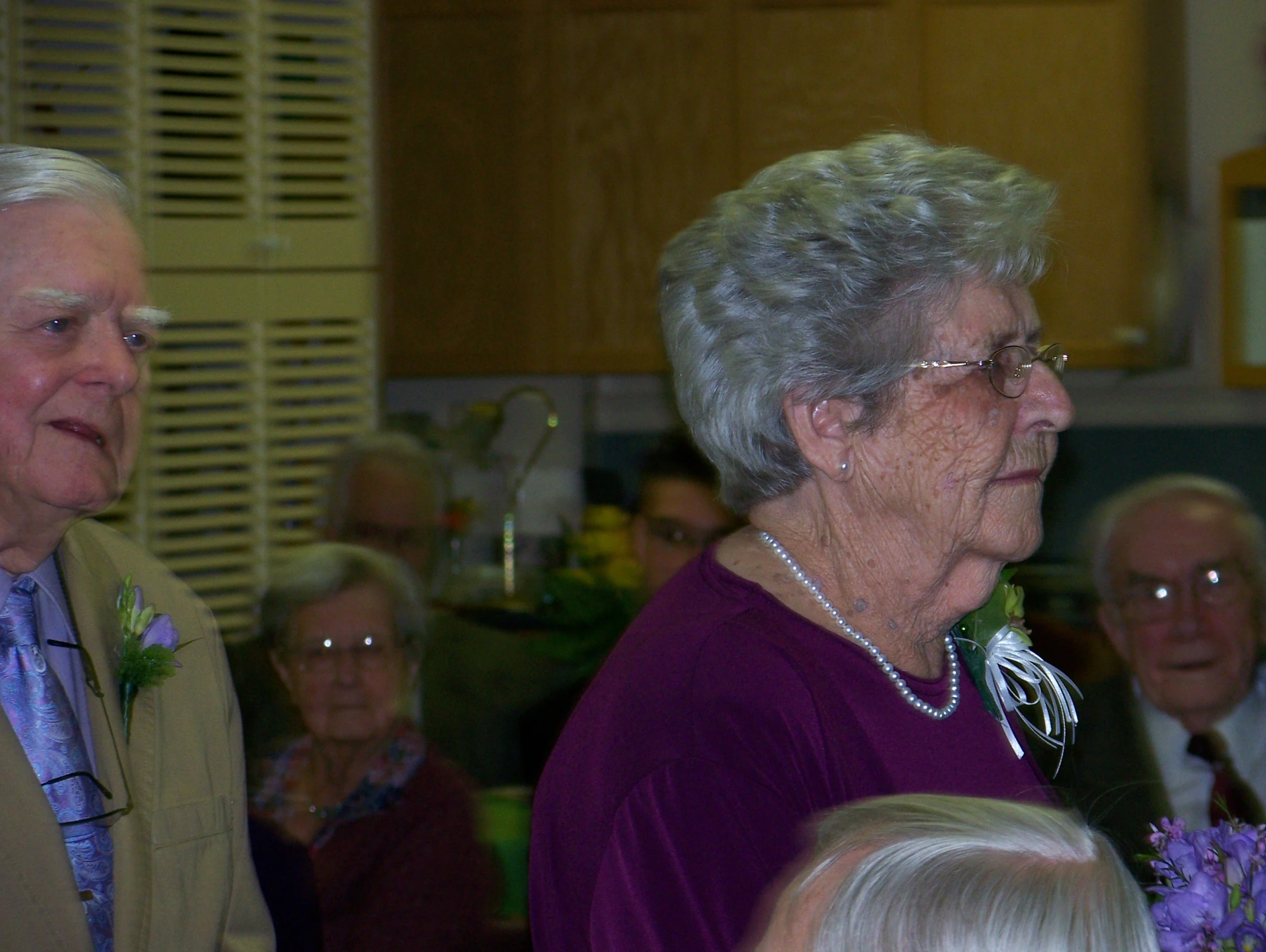 older women and men at a gathering for the funeral of a couple