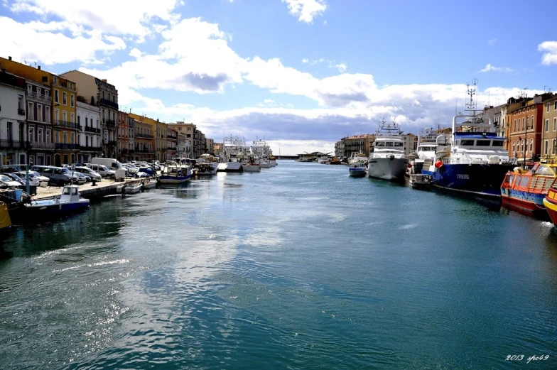 a river with small boats going through the city