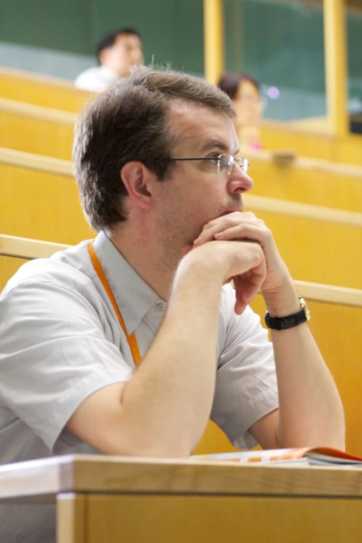 a man is looking to his left while seated in the court