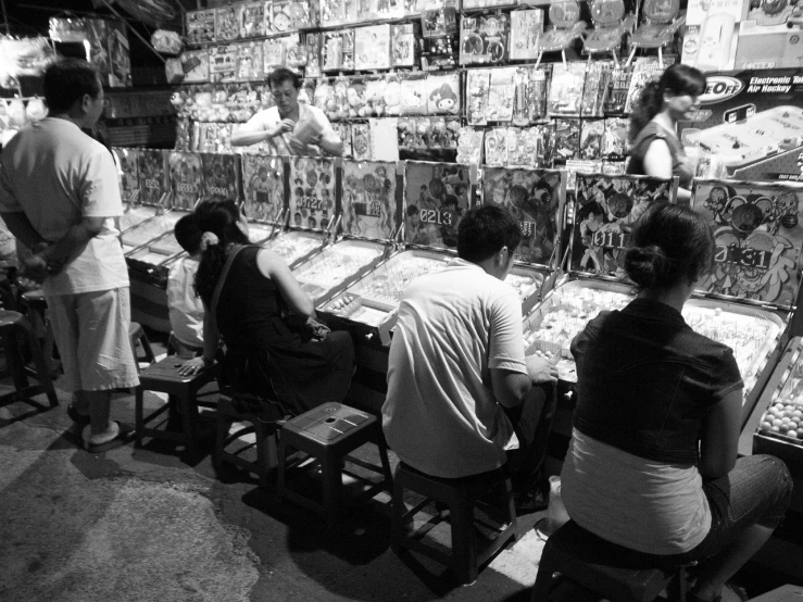 an arcade gaming booth filled with people in it