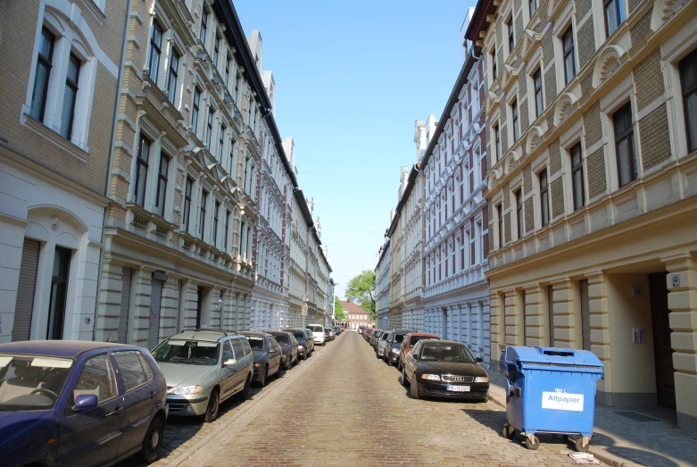 three cars parked on both sides of a sidewalk