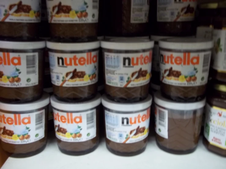 chocolate spread with nutshell in jars sitting on a shelf