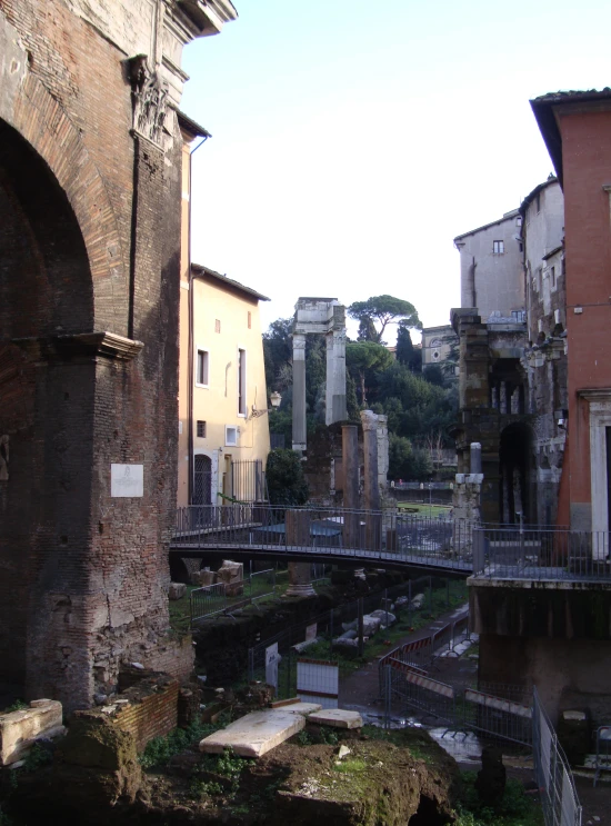 a building with a bridge going over it in a very old city