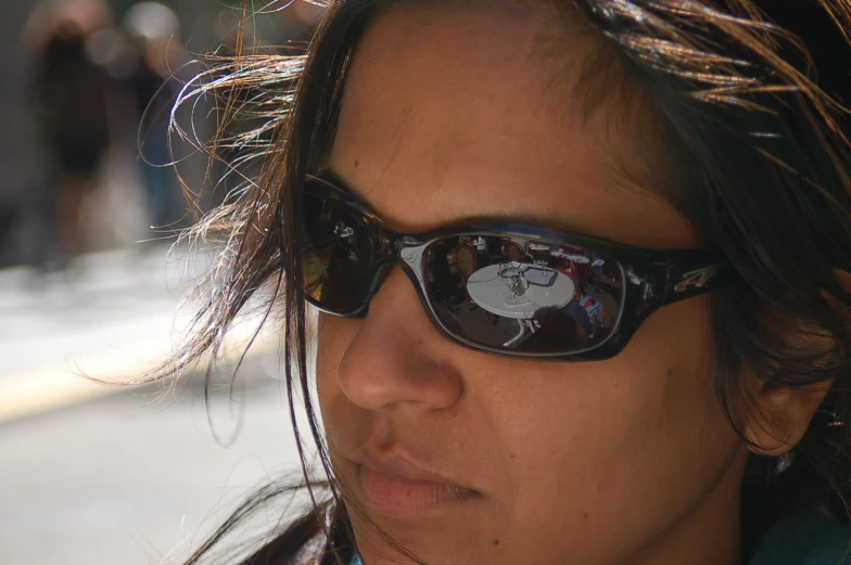 woman in sunglasses taking a selfie on the street