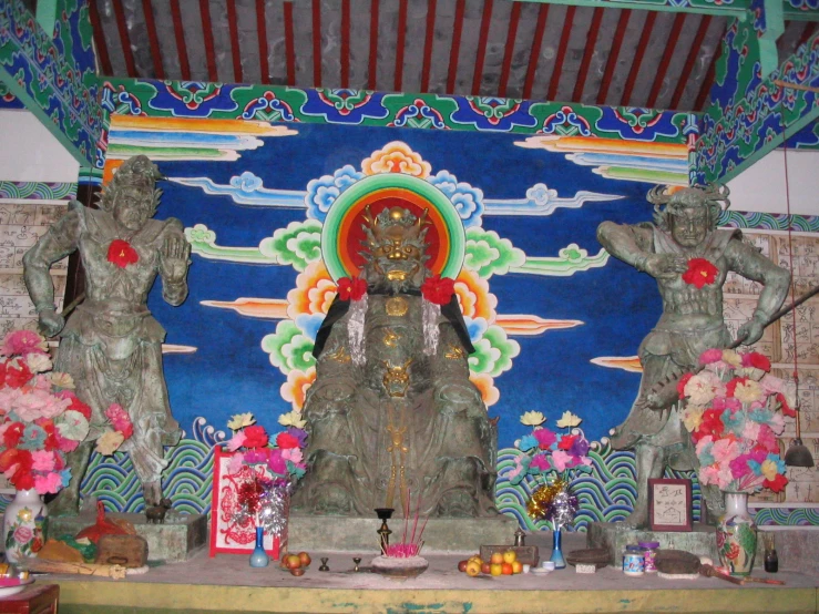 the statue of an oriental woman is surrounded by other decorations