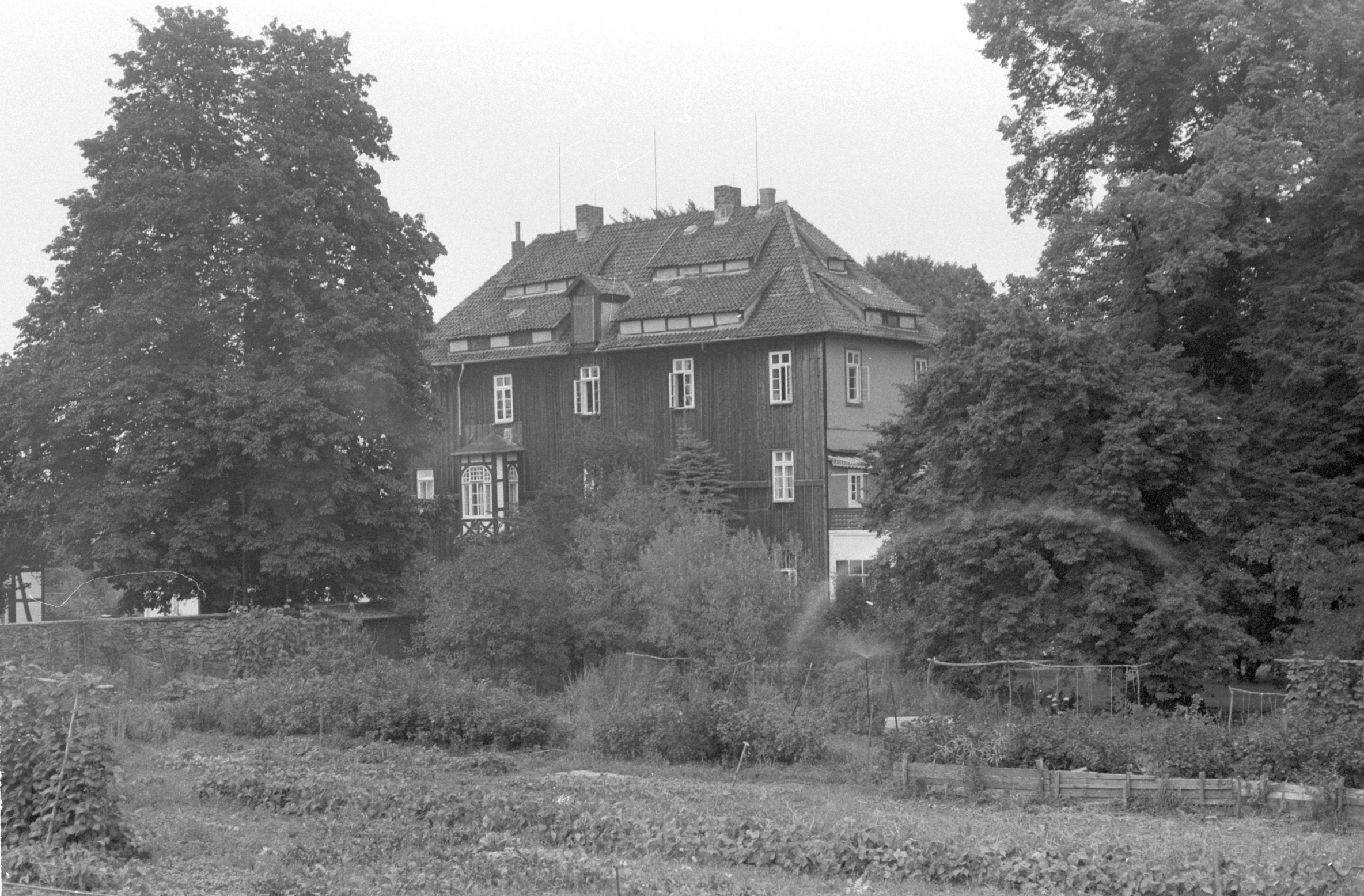 this old home is in a lush green field