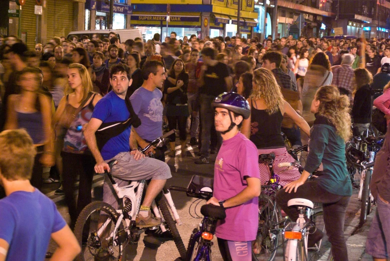 a crowd of people on bikes standing around
