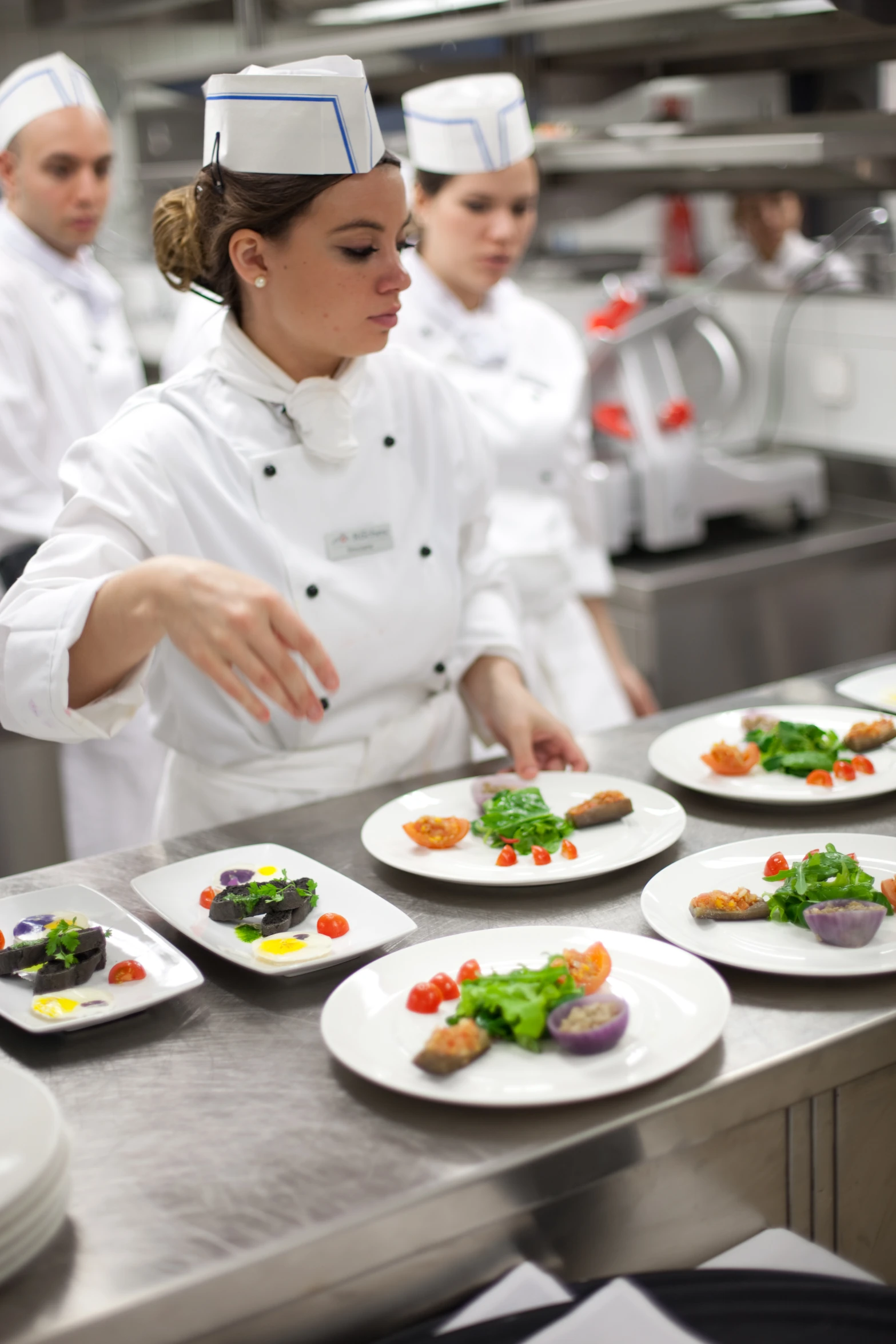 there are many chefs standing in the kitchen