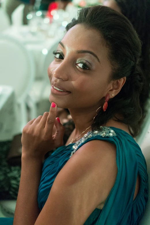 a young lady wearing some kind of dress in a dining room