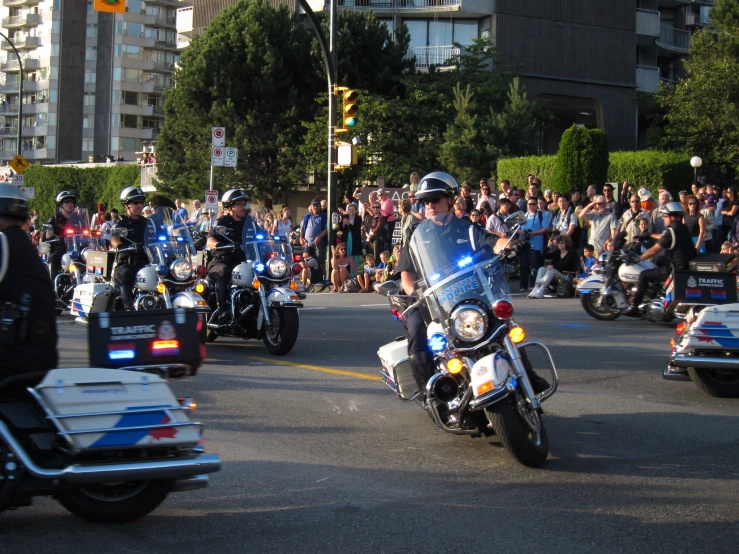 police on motorcycles driving through a parade