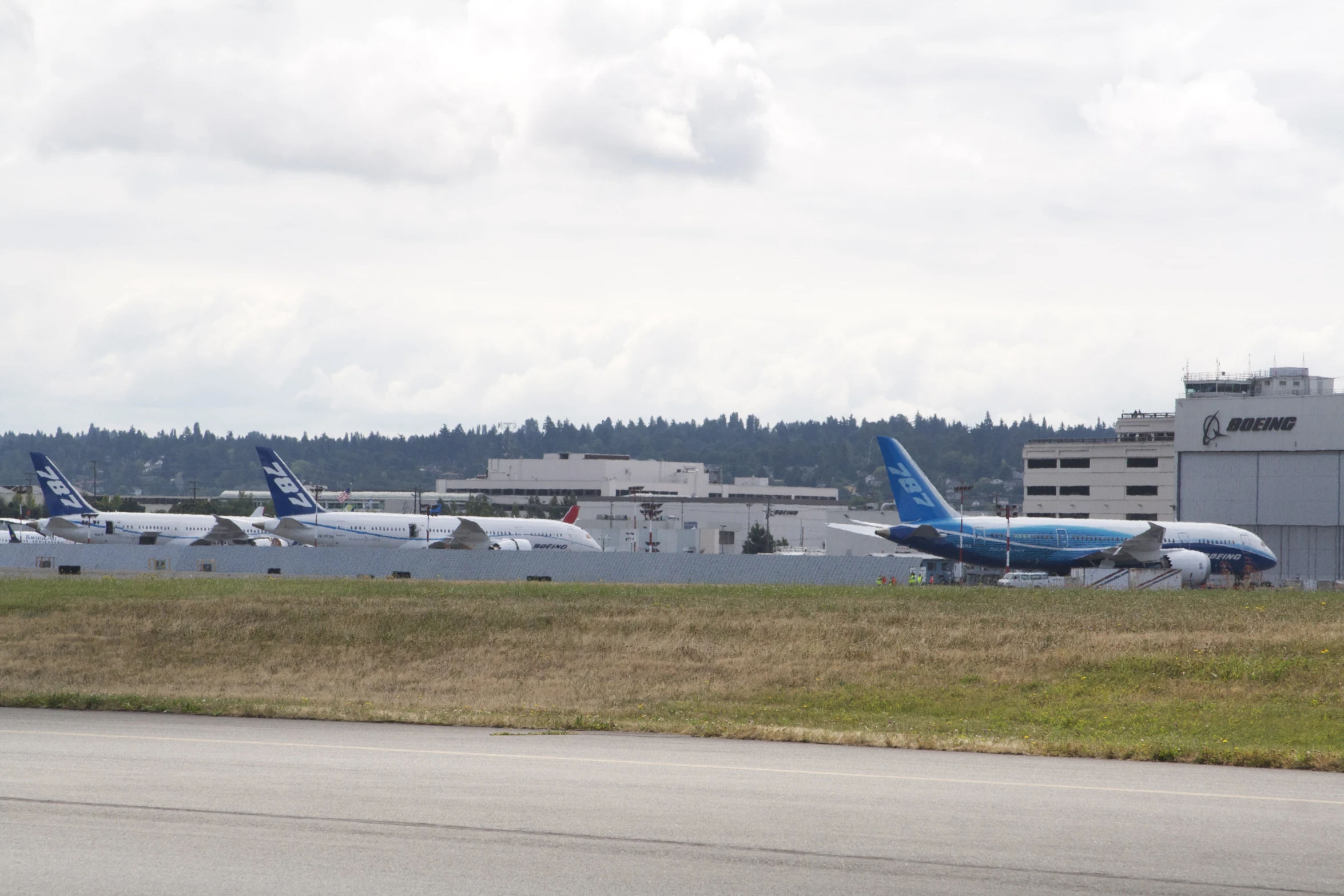 three airplanes sitting on the tarmac of an airport