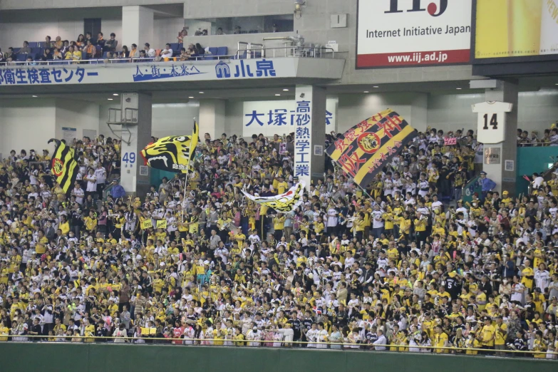 a big crowd at a stadium with many signs in front of them