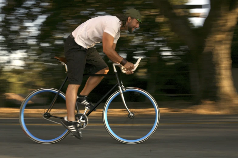 a man riding a bike with blue rims