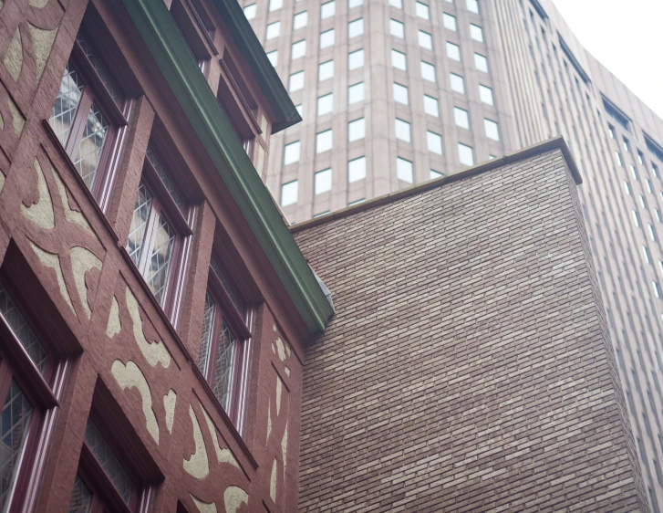 a clock and building face the city with many windows