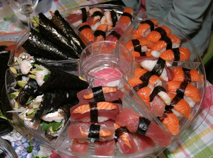 several types of sushi served in plastic containers