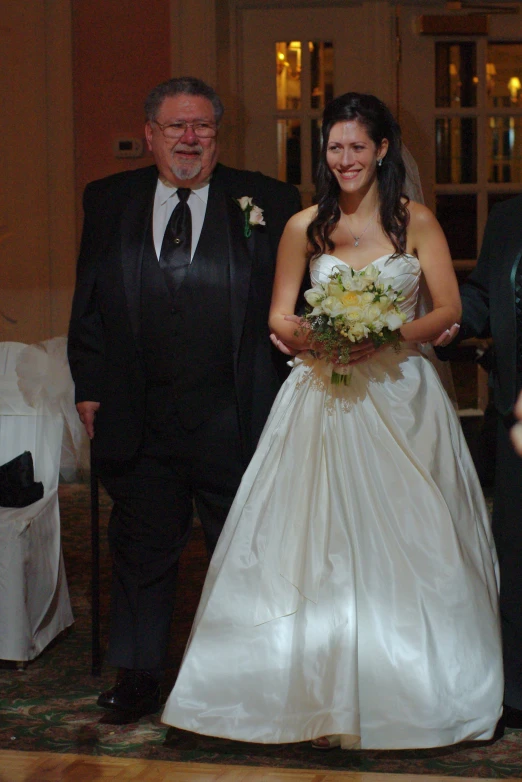 man and woman walking down the aisle to their wedding ceremony