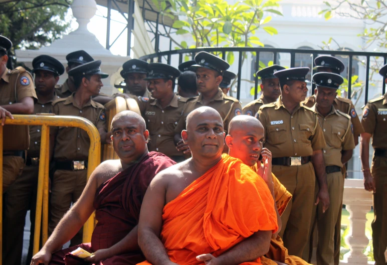 a group of cops and a man sitting down