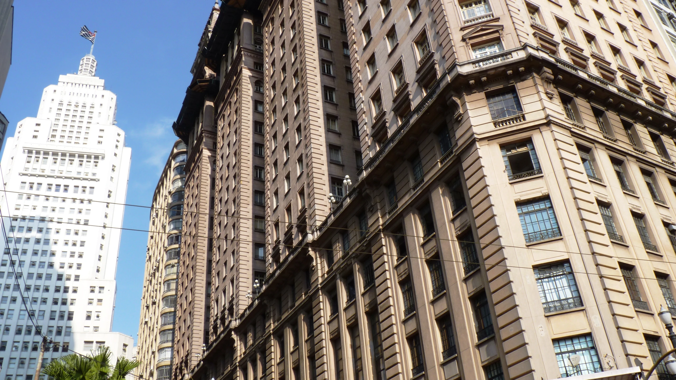 large buildings with towers in the background against a blue sky