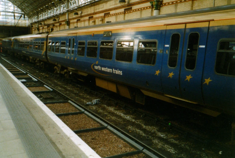 the side of a train is blue with gold stars