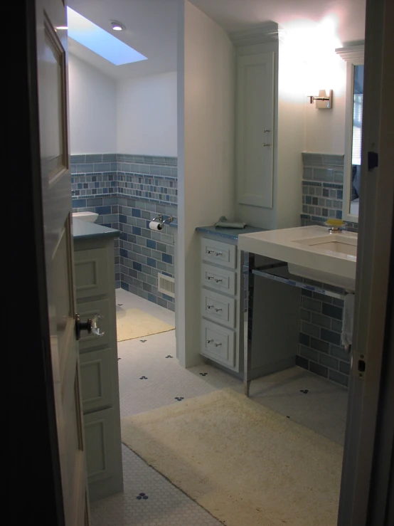 an empty white bathroom with blue brick walls