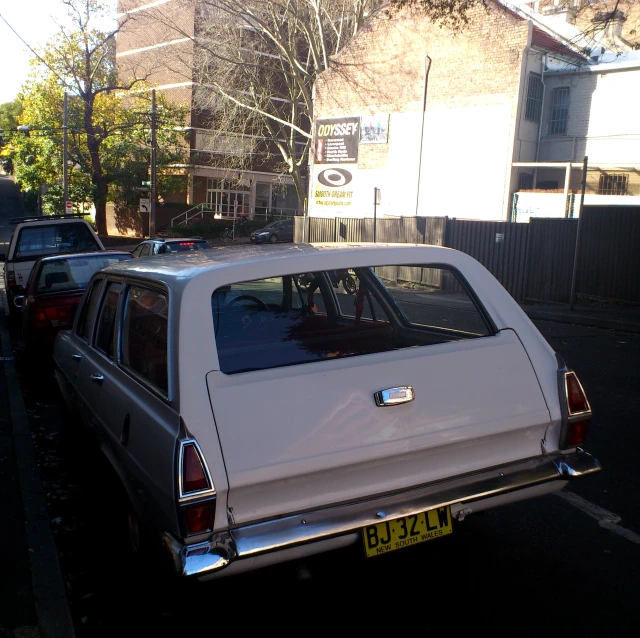 an image of a white car parked on the street