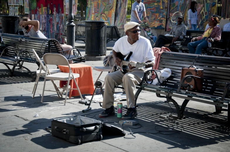 a man playing the guitar in the sun