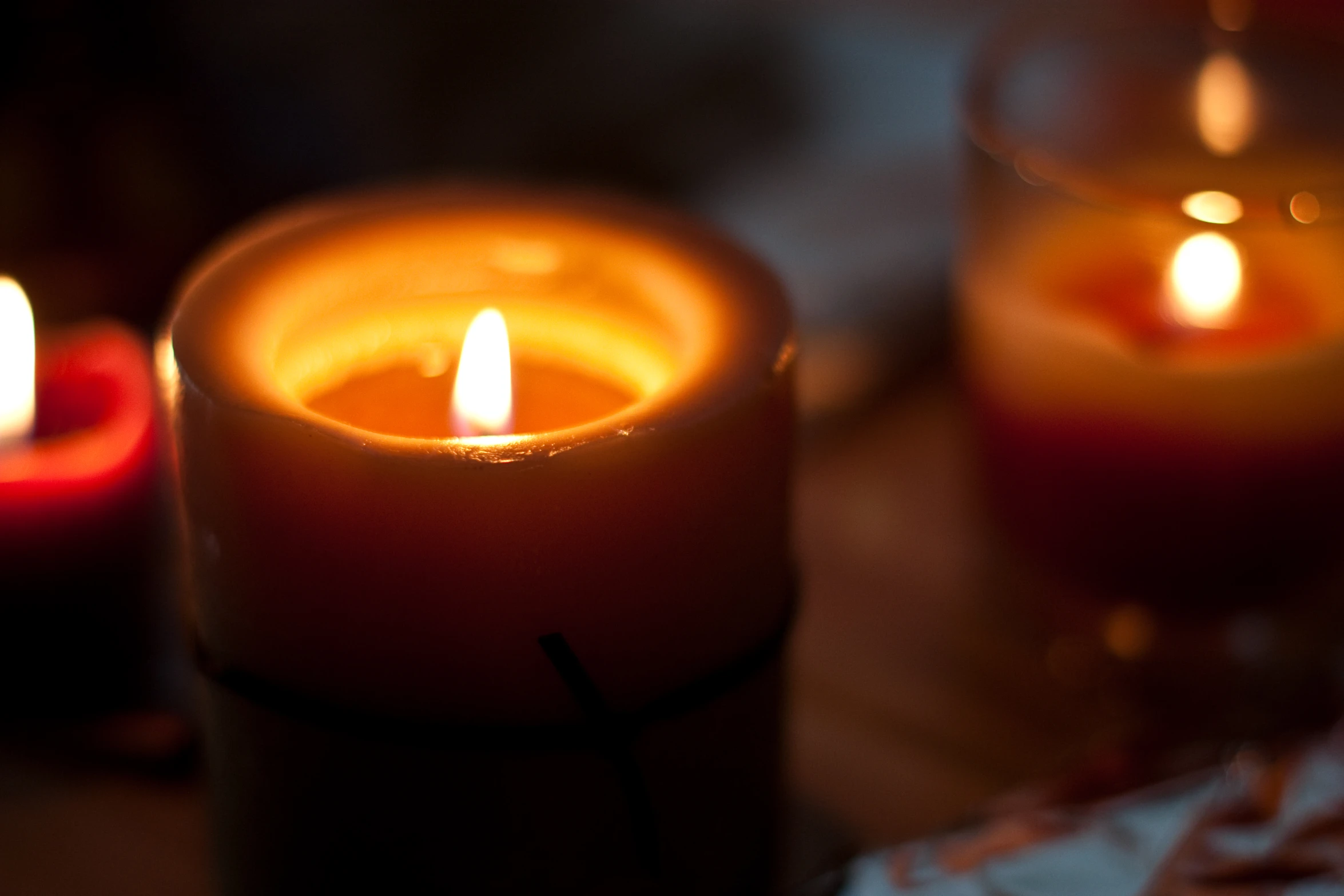 there are several lit candles sitting next to each other