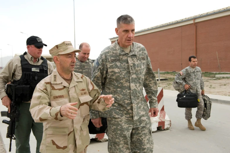 military men in uniforms and walking on the street