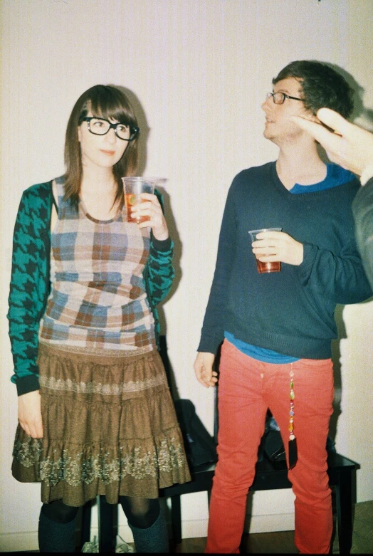 two people dressed up as two people who are drinking from cups