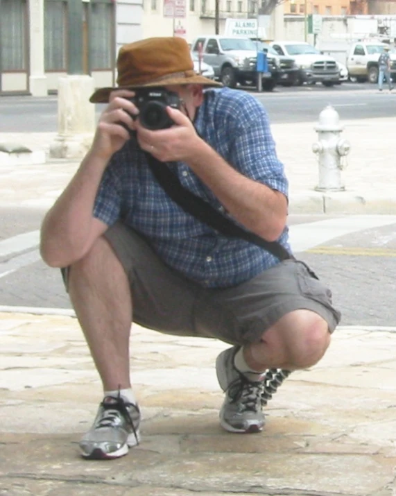 a man taking a po on the side of a street