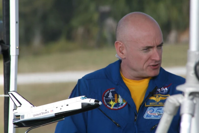 a man is standing next to a model jet