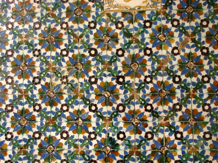 the tile is decorated with decorative flowers and leaves