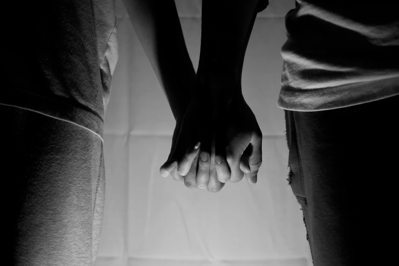 a couple holding hands standing next to each other