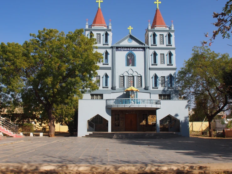 a church with two towers is located on the other side of a parking lot