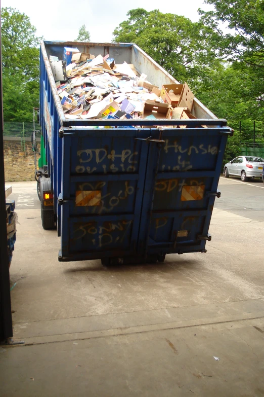 a dump truck with garbage in it on the road