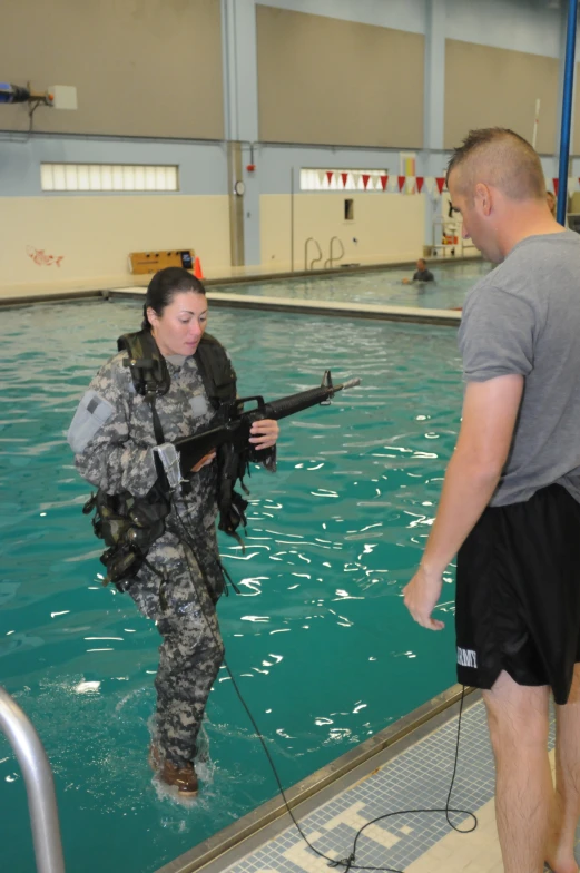 the man is standing in the water near the woman