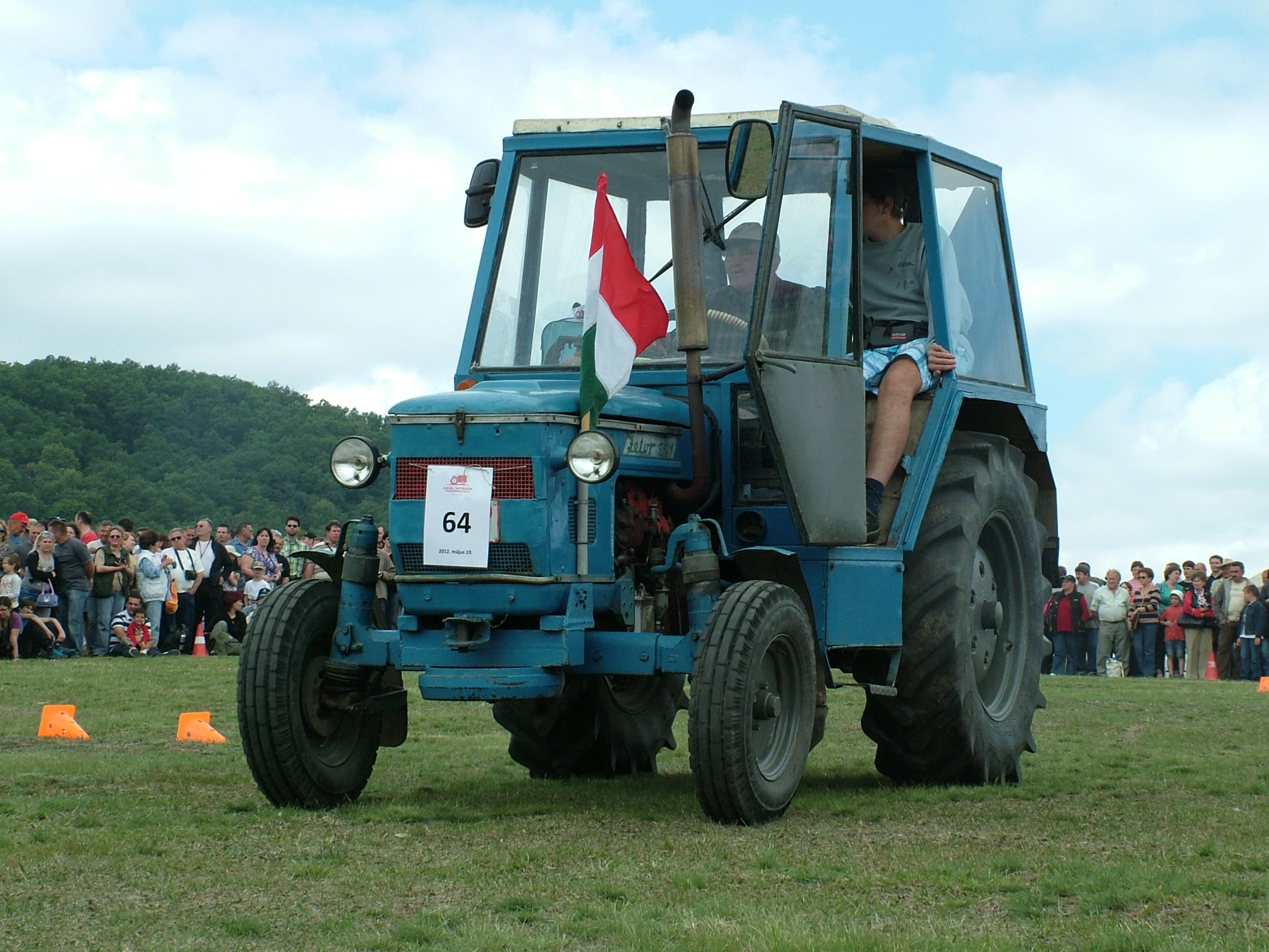 people watching people ride in the back of a tractor