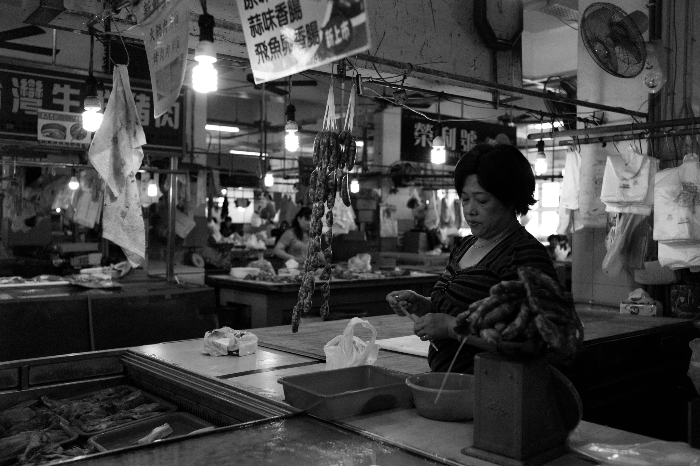 a woman working in a food market with lots of items