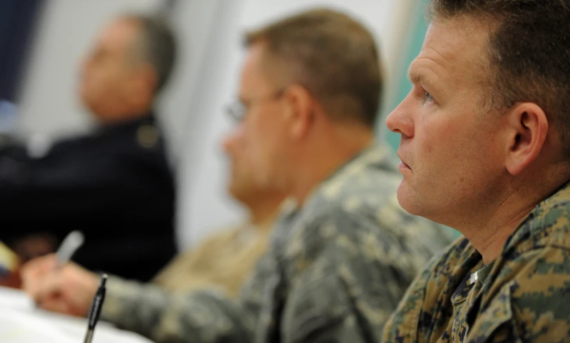 two men in uniform sitting at a table