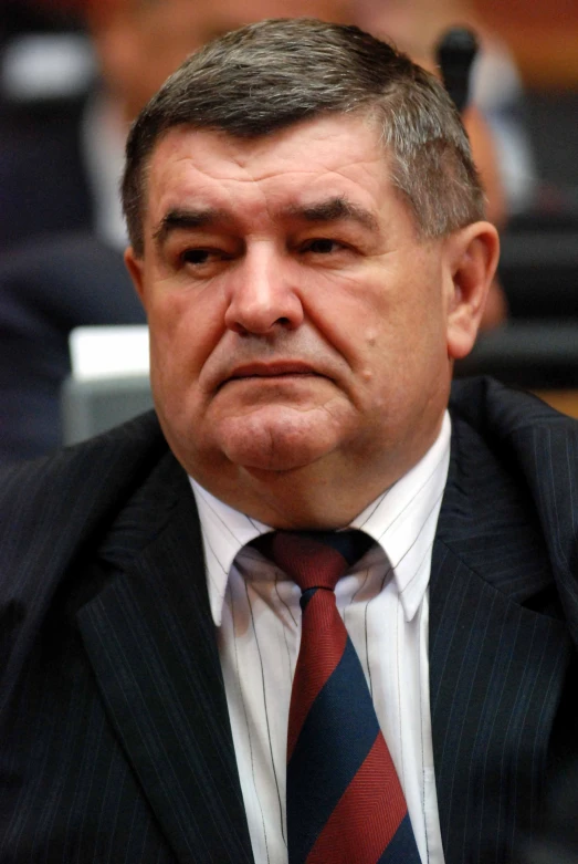 a close up po of a man wearing a tie