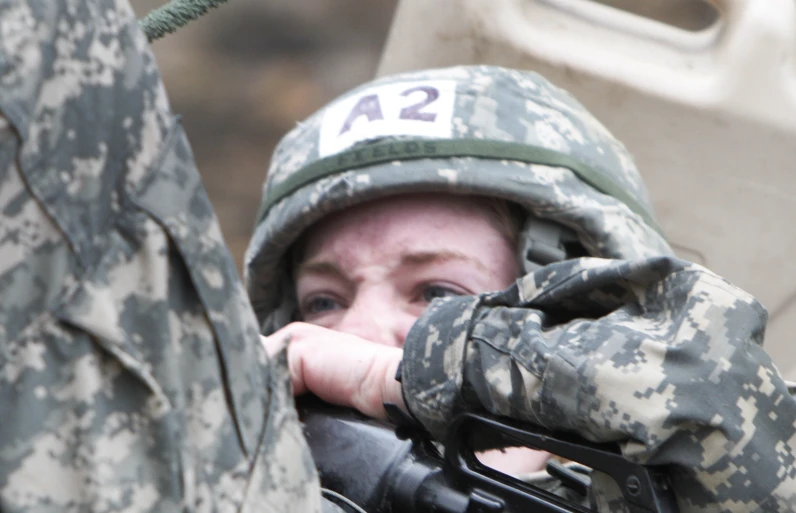 a woman wearing a helmet while looking at soing