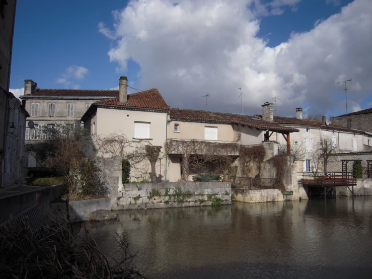 an old village by a river is seen in the background