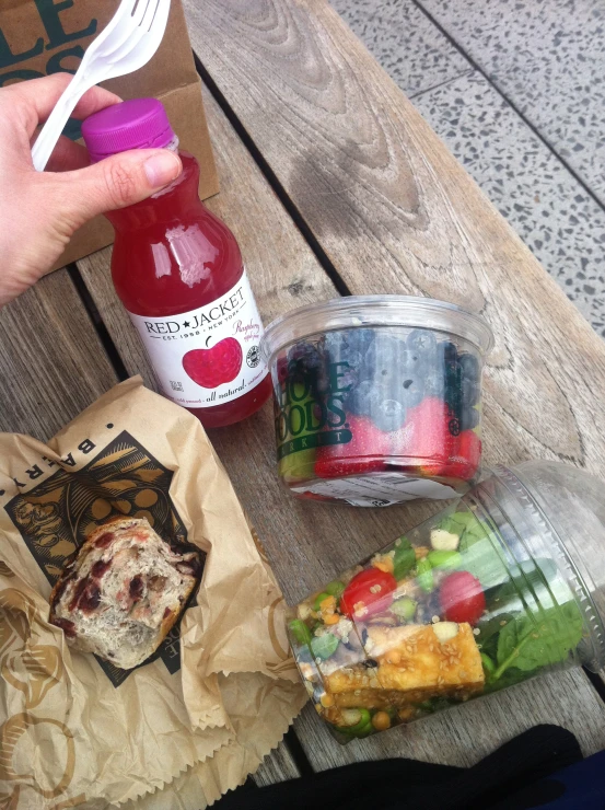 some ketchup and salad salads on a wooden table