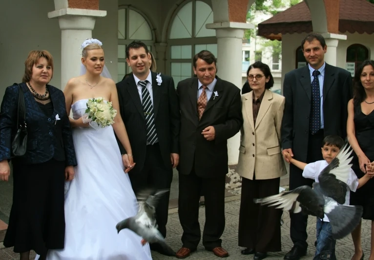 some very well dressed people standing near one another