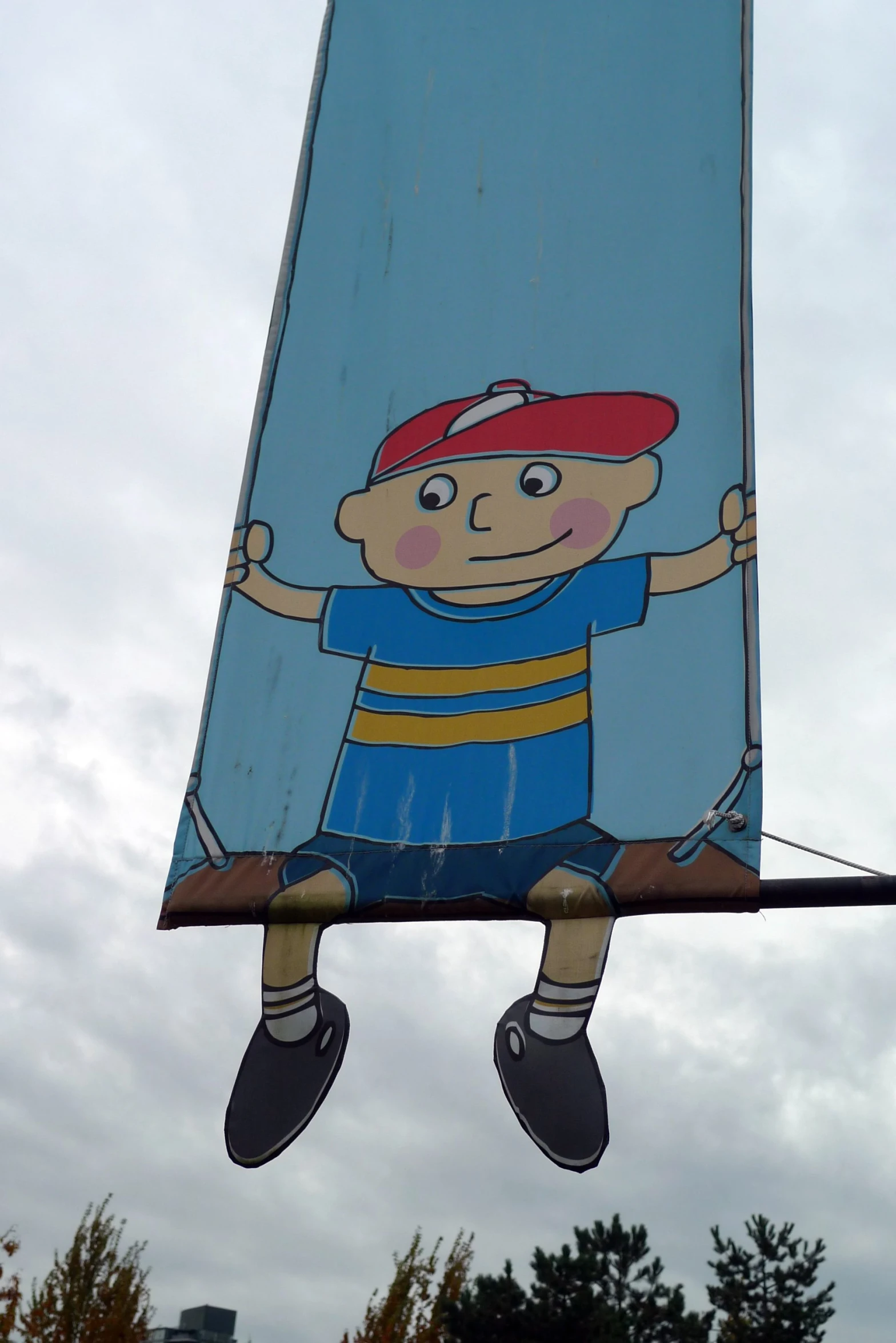 a poster on the side of a road shows a child in blue